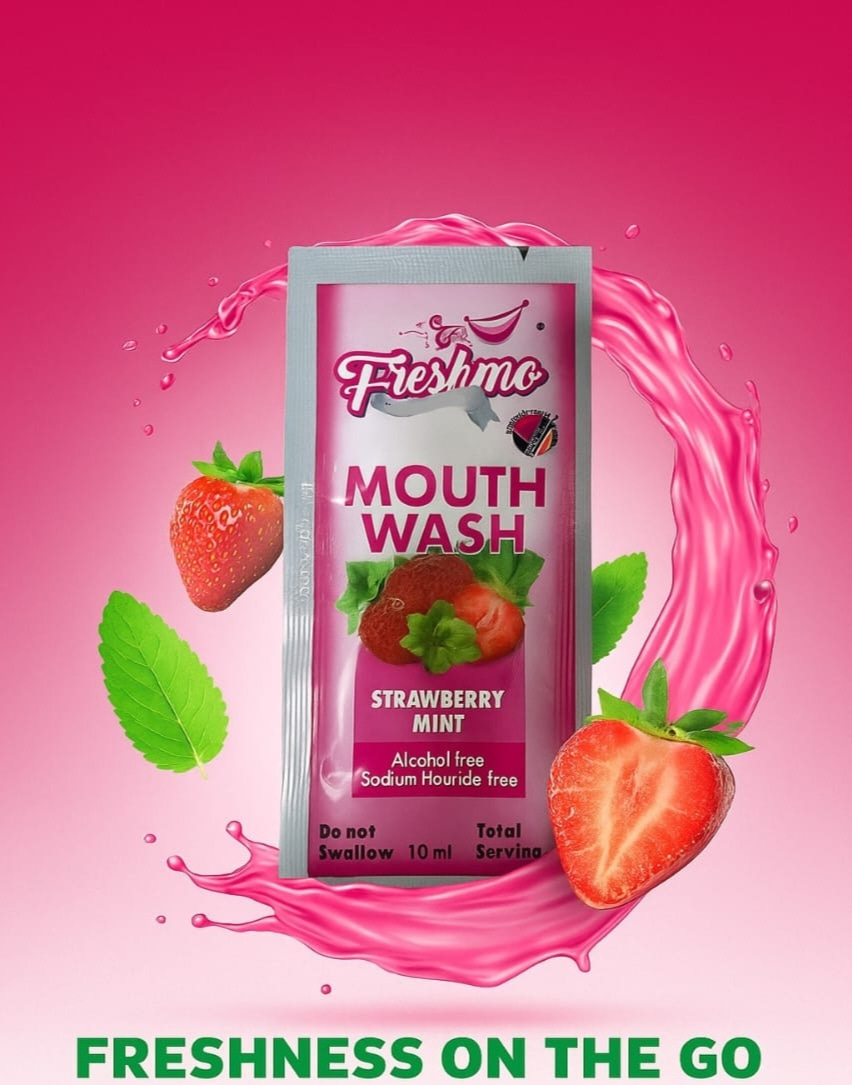 Freshmo Strawberry Mint mouthwash sachet with a splash of pink liquid, fresh strawberries and mint — freshness on the go